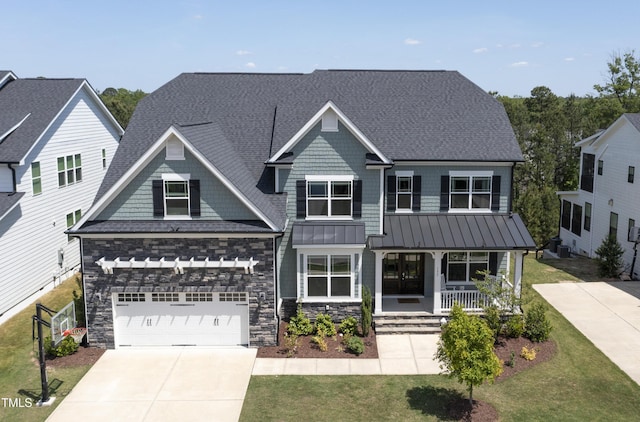 craftsman-style home featuring a porch, a standing seam roof, driveway, a front yard, and roof with shingles
