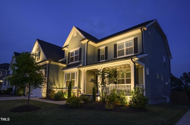 craftsman-style home with a porch and stone siding