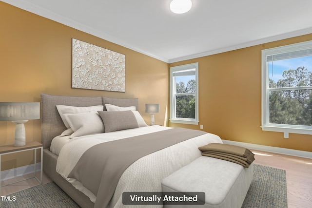 bedroom featuring baseboards, crown molding, and multiple windows
