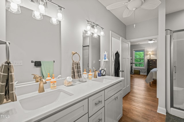 ensuite bathroom with double vanity, ceiling fan, a sink, and ensuite bathroom