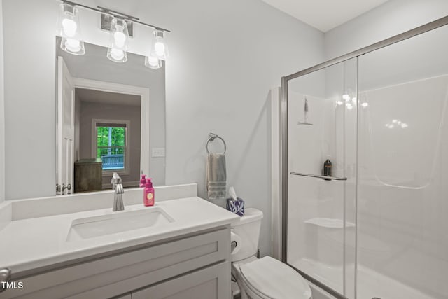 full bathroom with vanity, toilet, and a shower stall