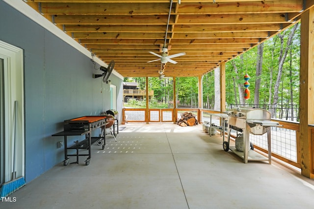 unfurnished sunroom featuring a ceiling fan