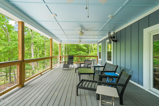 wooden terrace featuring a ceiling fan