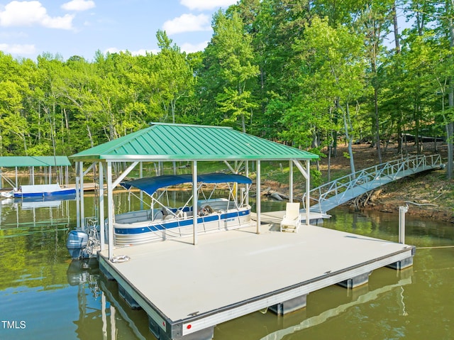 dock area with boat lift and a water view