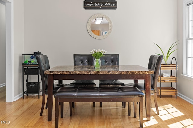 dining room featuring baseboards and light wood-type flooring