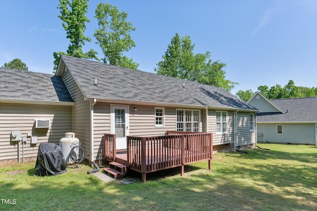 back of house featuring a yard, a deck, and roof with shingles