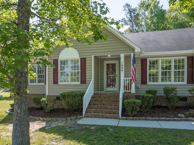 view of front facade featuring roof with shingles and crawl space