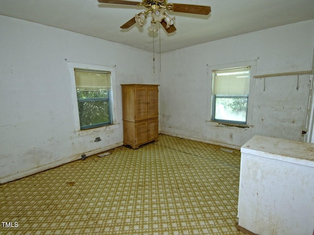 unfurnished room with ceiling fan and carpet floors