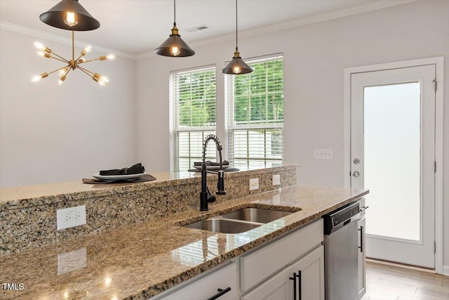 kitchen with dishwasher, a sink, hanging light fixtures, ornamental molding, and white cabinetry