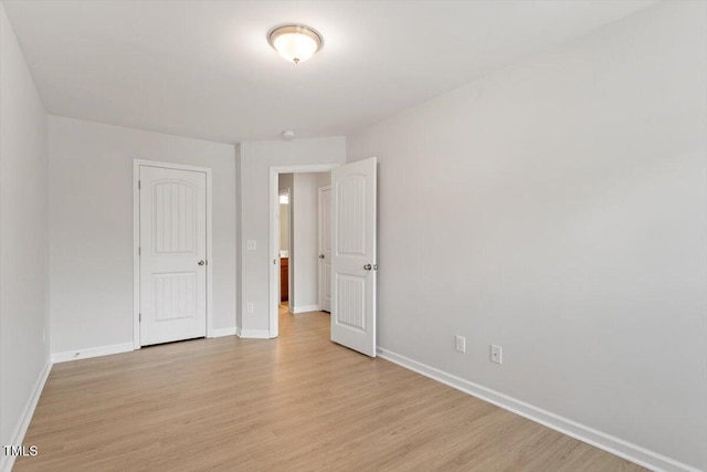 unfurnished room featuring light wood-style floors and baseboards