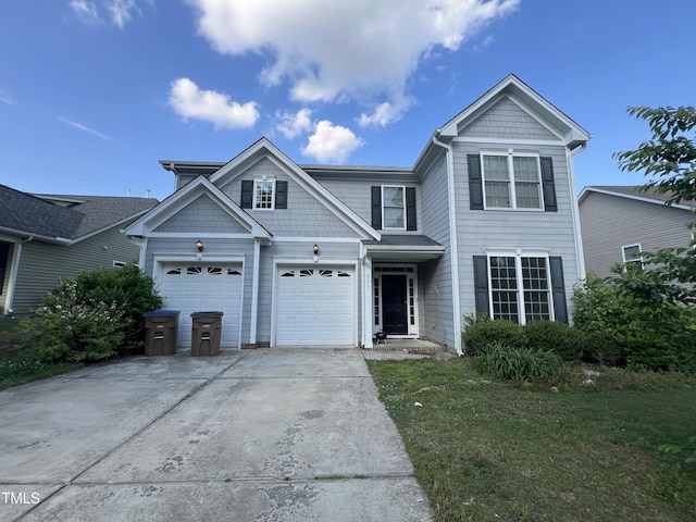view of front of home with concrete driveway, a garage, and a front yard