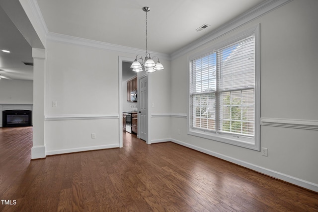 333 Trout Valley Rd, Wake Forest, NC 27587 - unfurnished dining area featuring a chandelier, ornamental molding, a glass covered fireplace, and dark wood-style floors