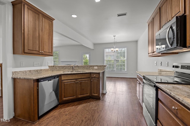 333 Trout Valley Rd, Wake Forest, NC 27587 - kitchen with appliances with stainless steel finishes, dark wood-type flooring, a peninsula, a chandelier, and light stone countertops