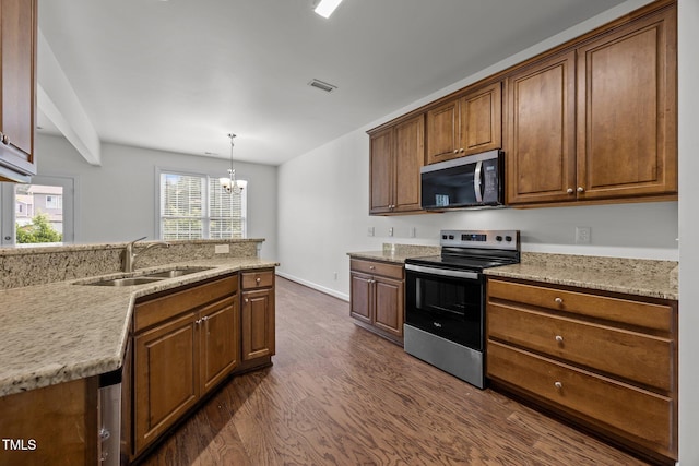 333 Trout Valley Rd, Wake Forest, NC 27587 - kitchen with appliances with stainless steel finishes, dark wood-style flooring, a chandelier, brown cabinets, and hanging light fixtures