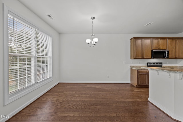 333 Trout Valley Rd, Wake Forest, NC 27587 - kitchen with stainless steel microwave, dark wood-style floors, a chandelier, and light stone countertops