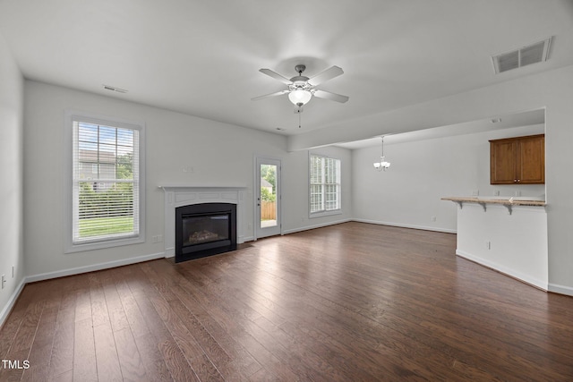333 Trout Valley Rd, Wake Forest, NC 27587 - unfurnished living room featuring a fireplace with flush hearth, ceiling fan, dark wood-style floors, and a chandelier