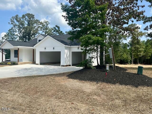 297 Dry Branch Dr, Kenly, NC 27542 - modern farmhouse featuring an attached garage and driveway