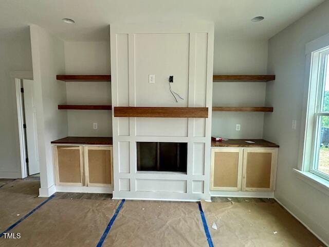 297 Dry Branch Dr, Kenly, NC 27542 - unfurnished living room featuring baseboards