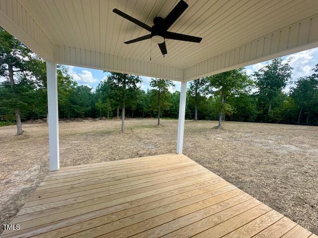 297 Dry Branch Dr, Kenly, NC 27542 - wooden terrace featuring ceiling fan and view of wooded area