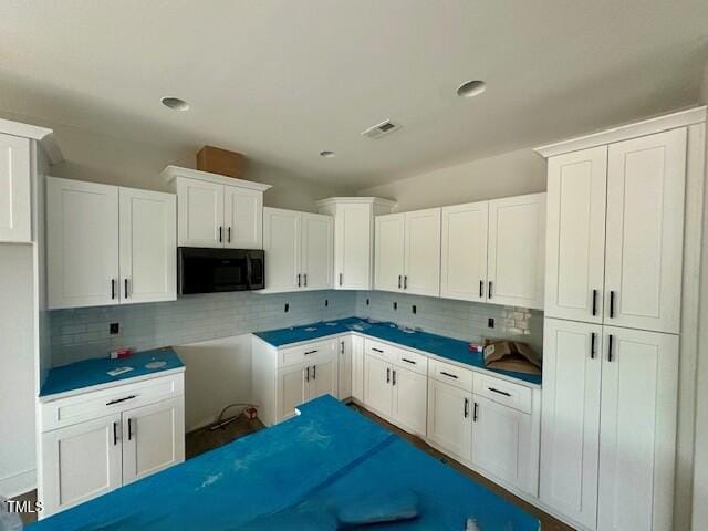 297 Dry Branch Dr, Kenly, NC 27542 - kitchen featuring black microwave, backsplash, white cabinetry, and recessed lighting