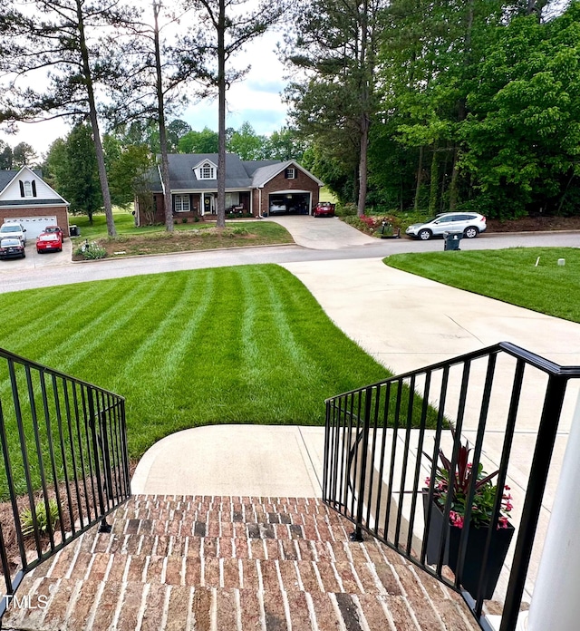 409 Eagle Ct, Henderson, NC 27536 - exterior space with fence, driveway, a front yard, and a garage