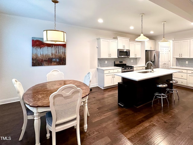409 Eagle Ct, Henderson, NC 27536 - kitchen with light countertops, stainless steel appliances, a sink, and tasteful backsplash