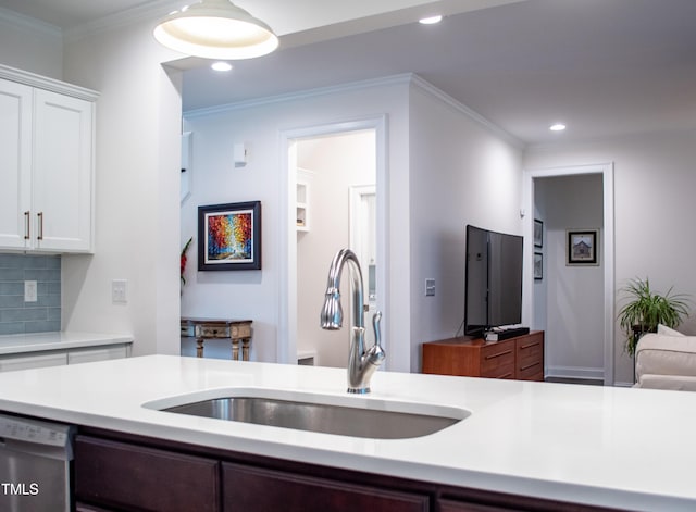 409 Eagle Ct, Henderson, NC 27536 - kitchen with light countertops, white cabinets, a sink, and dishwasher