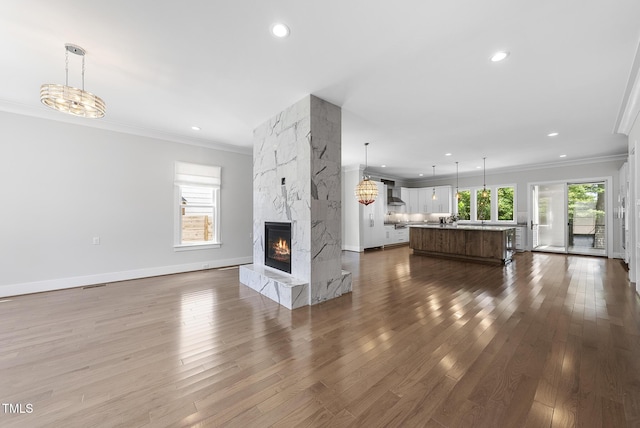 1820 Park Dr, Raleigh, NC 27605 - unfurnished living room featuring ornamental molding, dark wood-style flooring, recessed lighting, a fireplace, and baseboards