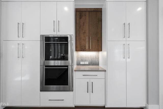 1820 Park Dr, Raleigh, NC 27605 - kitchen featuring double oven, modern cabinets, and light stone countertops