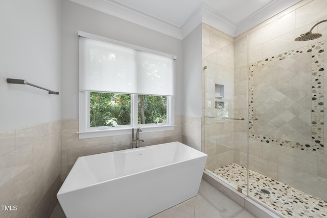 1820 Park Dr, Raleigh, NC 27605 - bathroom featuring tile walls, a stall shower, a freestanding bath, ornamental molding, and tile patterned flooring