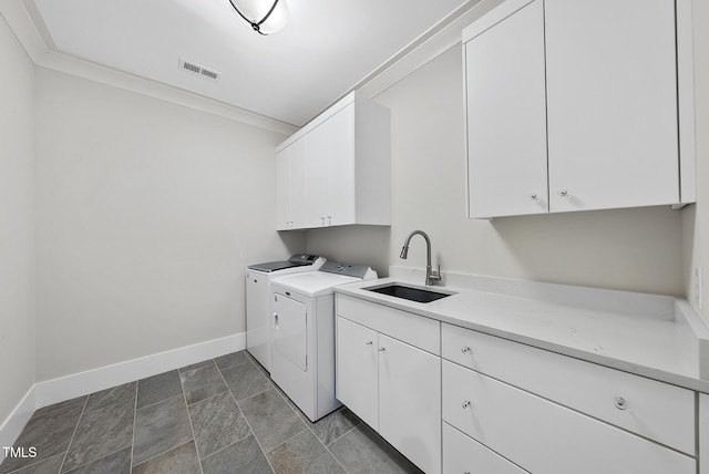 1820 Park Dr, Raleigh, NC 27605 - laundry room with cabinet space, washing machine and clothes dryer, baseboards, stone finish floors, and ornamental molding