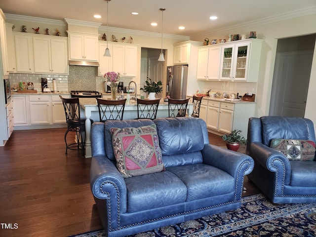 living area featuring dark wood-type flooring, recessed lighting, and crown molding
