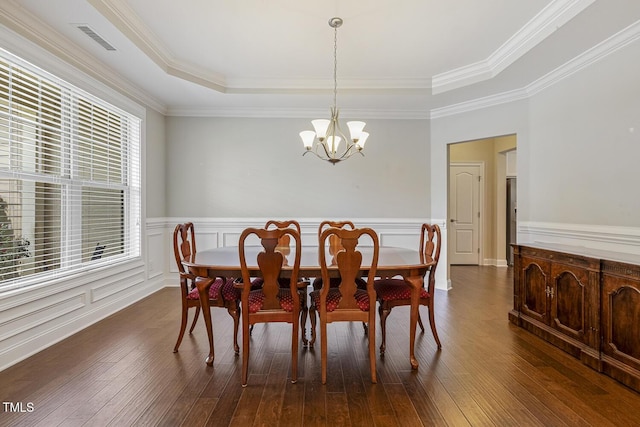 624 Meadowgrass Ln, Wake Forest, NC 27587 - dining room with a raised ceiling, a chandelier, dark wood-style floors, a wainscoted wall, and ornamental molding