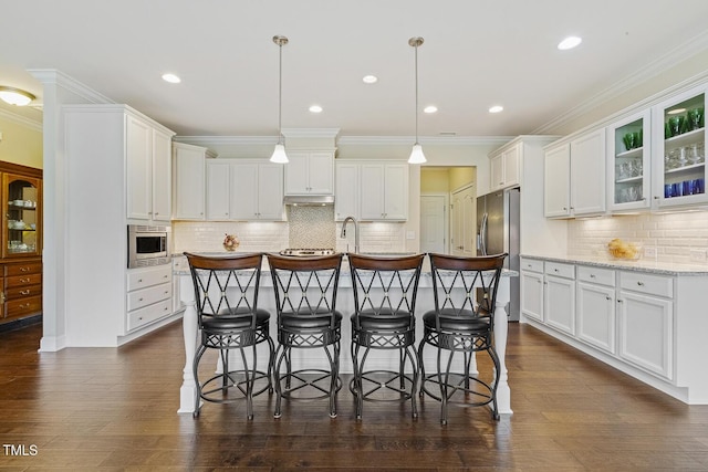 624 Meadowgrass Ln, Wake Forest, NC 27587 - kitchen featuring appliances with stainless steel finishes, a breakfast bar area, white cabinetry, decorative backsplash, and ornamental molding