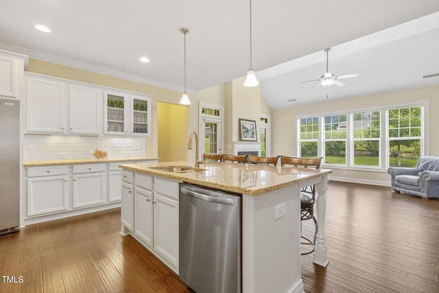 624 Meadowgrass Ln, Wake Forest, NC 27587 - kitchen featuring stainless steel appliances, a sink, a breakfast bar, white cabinets, and vaulted ceiling