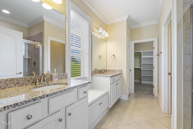 624 Meadowgrass Ln, Wake Forest, NC 27587 - bathroom featuring a stall shower, two vanities, tile patterned floors, ornamental molding, and a spacious closet