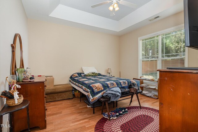 209 Mccarthy Dr, Clayton, NC 27527 - bedroom with wood finished floors, a raised ceiling, and a ceiling fan