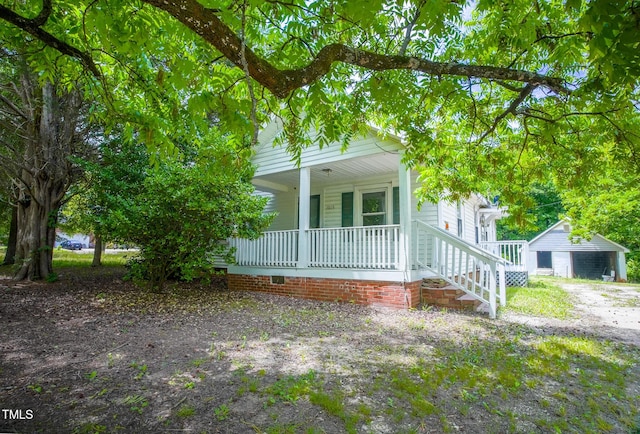 view of front of home featuring covered porch and an outdoor structure