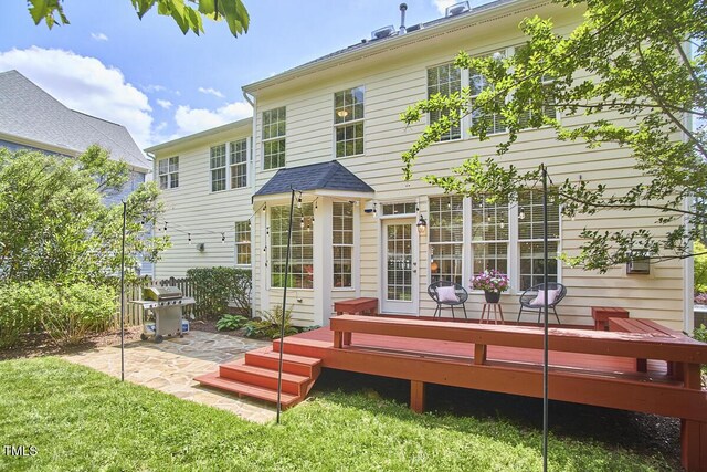 rear view of house featuring a yard, a patio, fence, and a deck