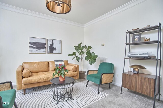 living area with baseboards, ornamental molding, carpet flooring, and visible vents