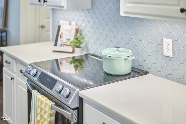 clothes washing area with wallpapered walls