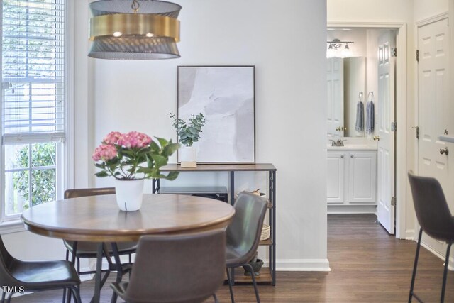 dining area featuring baseboards and dark wood-style floors