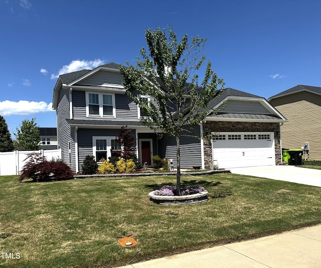 craftsman-style house with fence, driveway, a front yard, and a garage