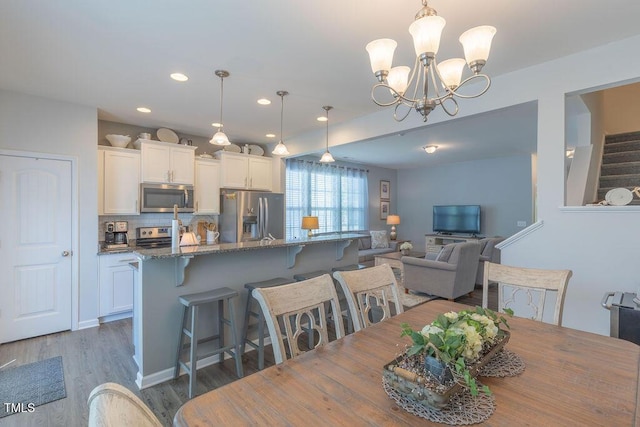 79 Hawkstone Dr, Clayton, NC 27527 - dining area with an inviting chandelier, recessed lighting, and wood finished floors