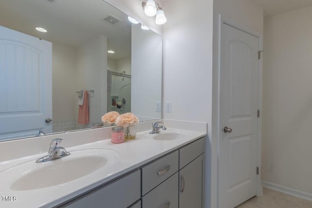 79 Hawkstone Dr, Clayton, NC 27527 - bathroom with visible vents, a sink, tile patterned flooring, and double vanity