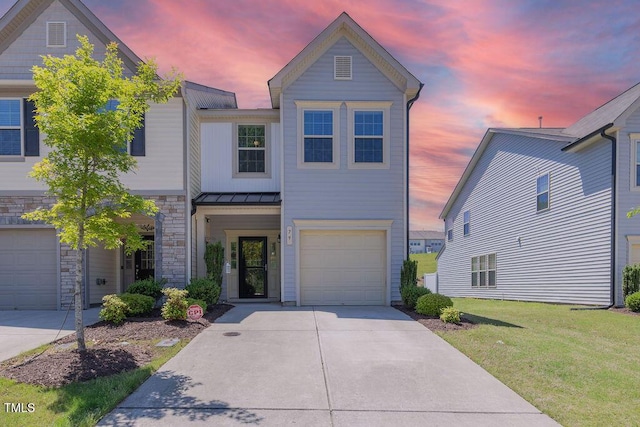 79 Hawkstone Dr, Clayton, NC 27527 - view of front facade with stone siding, a standing seam roof, concrete driveway, a lawn, and metal roof