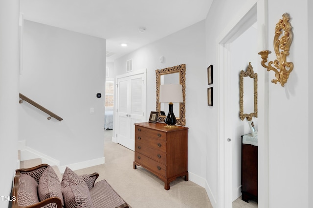 interior space featuring visible vents, recessed lighting, baseboards, and light carpet