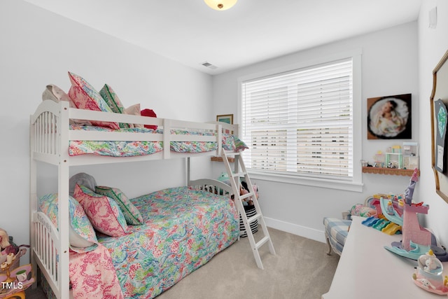 carpeted bedroom featuring baseboards and visible vents