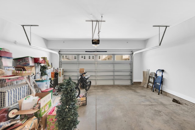 garage with baseboards and a garage door opener