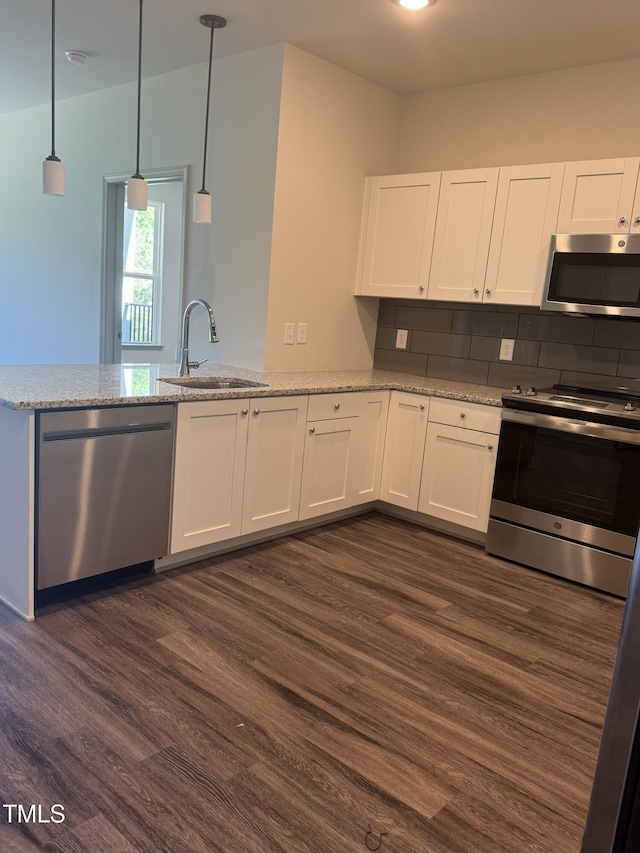 2418 Gathering Square Ct, Fuquay Varina, NC 27526 - kitchen featuring a sink, light stone counters, dark wood-style flooring, white cabinetry, and appliances with stainless steel finishes